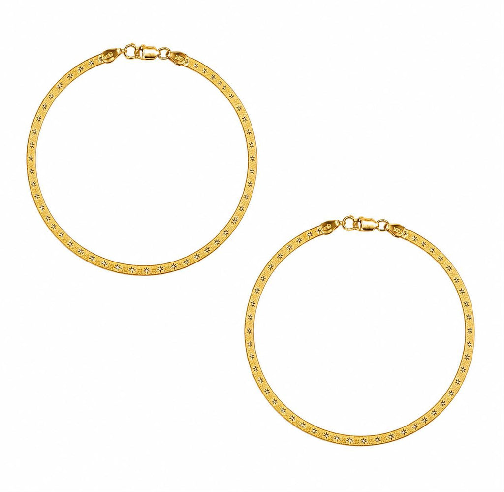 A pair of beautiful gold anklets with a textured, diamond-like pattern along the front, displayed on a clean white background.
