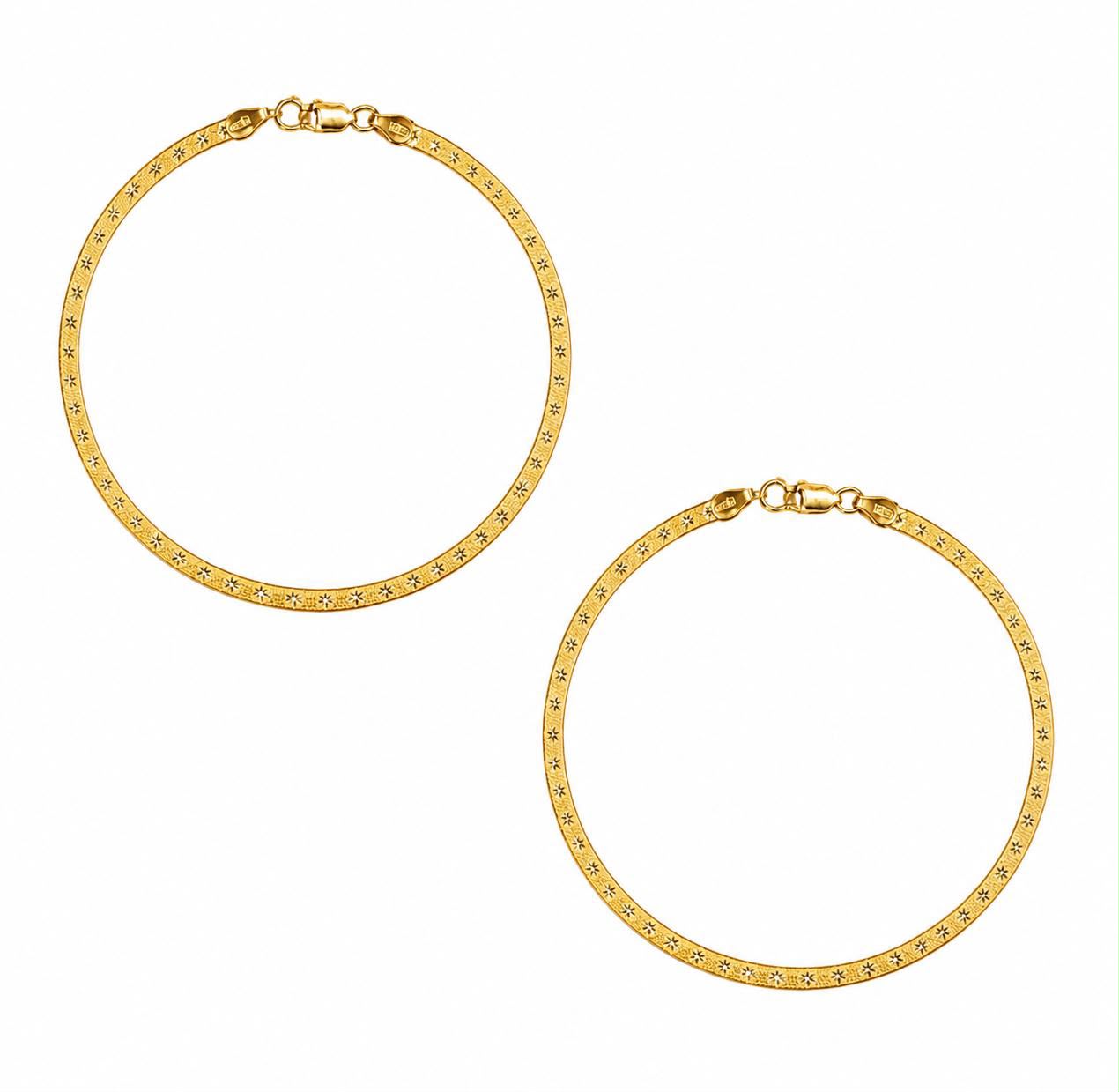 A pair of beautiful gold anklets with a textured, diamond-like pattern along the front, displayed on a clean white background.